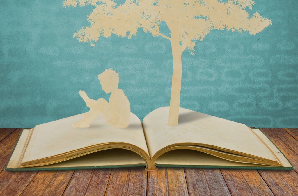 silhouettes-of-a-tree-and-a-man-on-a-book
